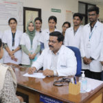 Medical students observing a faculty member during outpatient clinical training in a hospital OPD.