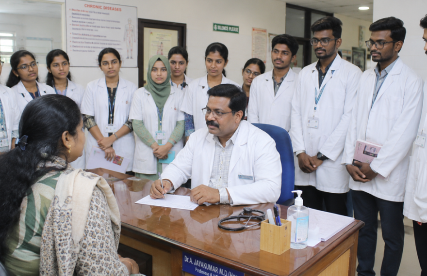 Medical students observing a faculty member during outpatient clinical training in a hospital OPD.